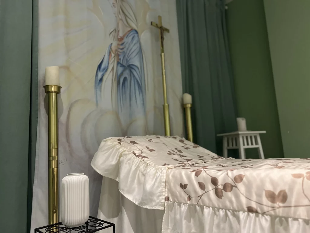 Décoration d'un salon funéraire avec fresque de la Vierge Marie et drapés.